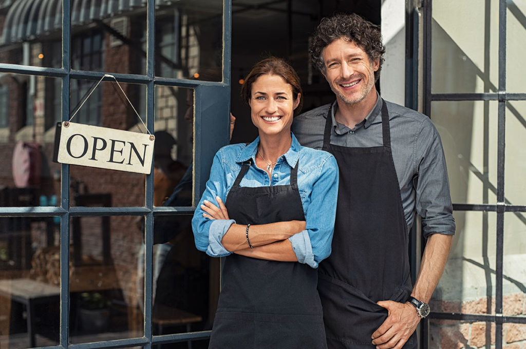 Business Owners with Open sign